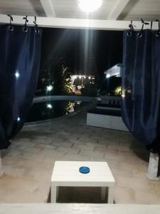 a blue frisbee on a table on a patio at night at Sole&Mare in Monopoli