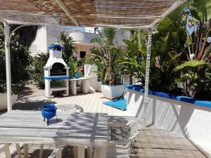 a patio with a table and chairs and a stove at Sole&Mare in Monopoli
