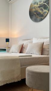 a bedroom with two beds and a clock on the wall at Apartments Ein Haus in der Sonne in Malinska
