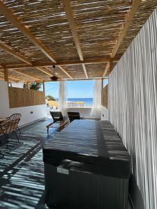 a living room with a table and a view of the ocean at SPONGIA HOTEL AND SUITES in Myrties