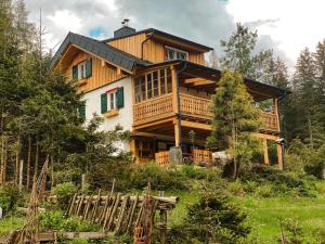 a large wooden house on top of a hill at Evas Boutique Alm in Kloster