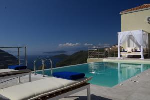 a swimming pool with a view of the ocean at Ilios villa in Fternón
