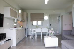 a kitchen and living room with a couch and a table at Ilios villa in Fternón