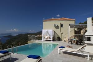 a villa with a swimming pool and a house at Ilios villa in Fternón