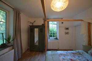 a bedroom with a bed and a large window at Haus im Grünen in Schneverdingen