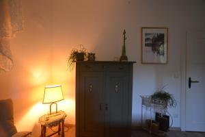 a room with a green cabinet and a lamp at Haus im Grünen in Schneverdingen