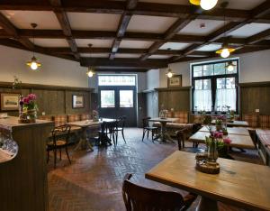 a restaurant with tables and chairs in a room at Shpatser hotel in Briukhovychi