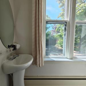 a bathroom with a sink and a window at Andy's Blue House in Charlottetown +48 photos