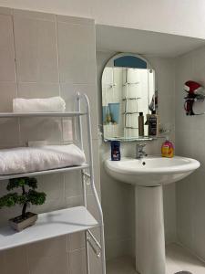 a bathroom with a sink and a mirror at Garden Villa Guni in Krujë