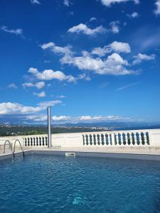 a swimming pool with a view of the water at Villa Antonio in Opatija