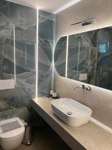 a bathroom with a sink and a toilet at Villa Diamond in Parga +39 photos