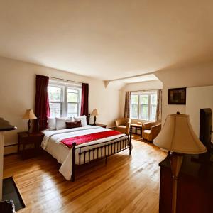 a bedroom with a bed and a living room at Andy's Blue House in Charlottetown