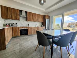 a kitchen with a dining room table and chairs at Al-Andalus, Chic Central Rooms in Victoria