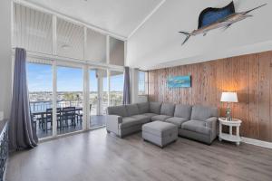 a living room with a couch and a table at St Thomas - Waterfront Penthouse sleeps 16 w Pool & Boat Dock in Key West