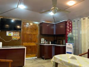 a kitchen with wooden cabinets and a ceiling fan at Movie land group of house boats in Srinagar