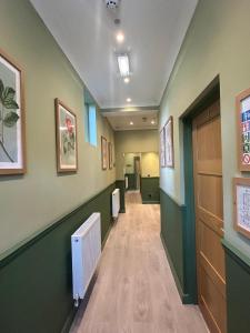 a hallway of a hospital with green walls and a radiator at Hamilton Court Hotel in Chester