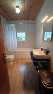 a bathroom with a toilet and a sink and a tub at Casa do Branco in Faja Grande +17 photos