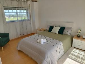 a bedroom with a large bed with towels on it at Vivenda Cordeiro in Bárrio