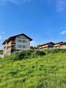 a building on top of a grassy hill at Nafta APARTS in Skhidnitsa