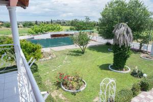 a view of a garden from the balcony of a house at Villa Regina By The Sea in Epanomi