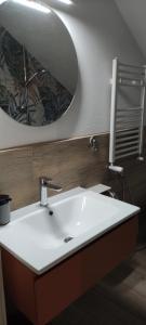 a bathroom with a white sink and a mirror at Appartamento di Porta Maggiore in Cupra Marittima