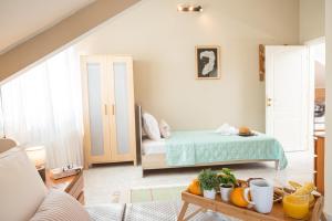 a room with a bed and a table with fruit on it at Villa Regina By The Sea in Epanomi +115 photos