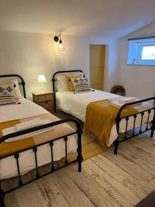a bedroom with two beds and a window at Cantinho da Villa in Portel +29 photos