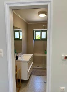 a bathroom with a tub and a sink and a shower at Alexander House 2 in Leonidio +39 photos