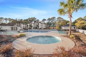 a swimming pool in a yard with a palm tree at Stunning 3 Bedroom Condo-Recently Renovated-Fairways Unit D in Myrtle Beach