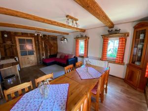 a living room with a table and chairs and a couch at Apartmány u Dostálů in Bedřichov
