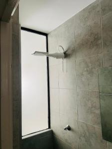 a shower with a window in a bathroom at Gem by T in Rongai with a pool in Ongata Rongai 
