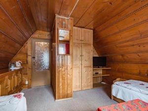 a room with two beds and a television in a cabin at Dom Lesnik in Zakopane