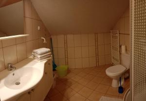 a bathroom with a sink and a toilet at Darłowska 49A in Dąbki +13 photos