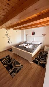 a bedroom with a bed in a room with wooden ceilings at Casa Morarului in Buşteni