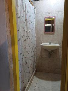 a bathroom with a sink and a shower curtain at Cabañas Arrecifes in El Valle +93 photos
