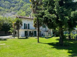 a house with a hammock in a yard at Al Piccolo Pontile Como lake in Mandello del Lario