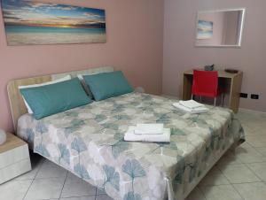 a bedroom with a bed with two chairs and a desk at millennium holiday in Castellammare del Golfo