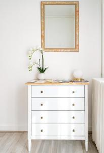 a dresser with a mirror on top of it at Villa Vichéia - Appartement 2 in Vichy