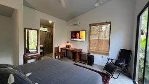CóbanoにあるPochote River houseのベッドと机と窓のある寝室