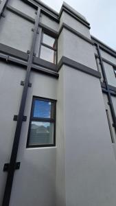a building with windows on the side of it at Apartment 1 - Haddin Court - Executive One Bedroom in Blenheim