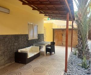 a patio with a table and a couch and a table at Beira Mar AB2 in Santa Maria