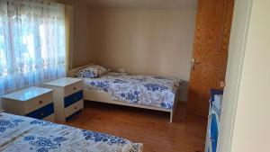 a small bedroom with two beds and a window at Dream Home in Pogradec