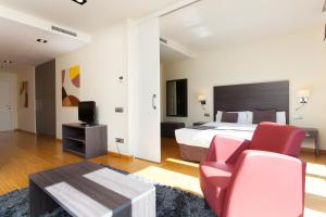 バルセロナにあるWeflating Modern Diagonalのベッドルーム1室(ベッド1台、赤い椅子2脚付)