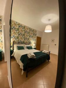 a bedroom with a large bed with a mirror at Casa Vacanze Fonte del Menotre in Foligno