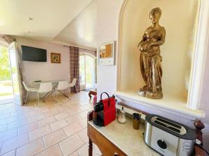 a statue of a woman standing in a living room at Villa Les Reflets - Lac, Vue panoramique, piscine in Montauroux