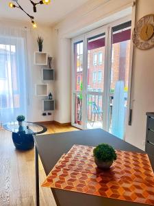 a living room with a table and a view of a building at BolognaBySide -RIGHI in Bologna