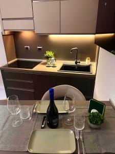 a kitchen with a table with a bottle of wine on it at BolognaBySide -RIGHI in Bologna