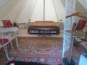 a room with a bed in a tent at terrebio Glamping in Visnadello +4 photos