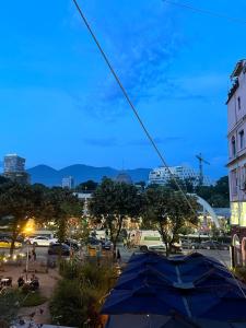 a view of a city with a blue umbrella at Midtown Cozy Apartment in Tirana