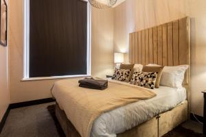 a bedroom with a bed with a large window at Crown Street Aparthotel in Halifax